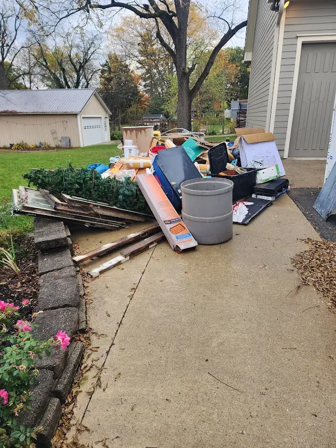 Dumpster being loaded with debris for 12 Yard Dumpster Rental in St. Johnsbury